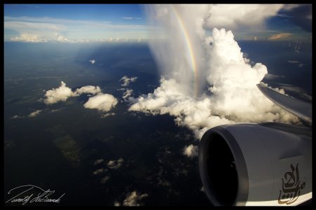 Clouds and rainbow from a plane.jpg