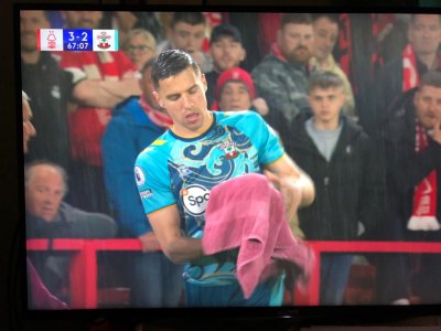 Footballer drying football in the rain..jpg