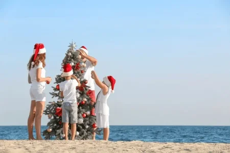 happy-family-celebrating-christmas-tropical-600nw-1851805657.webp